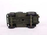 a toy army truck with four wheels on a white surface