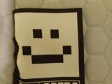 a patch on the back of a chair with a smiley face on it
