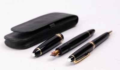 three pens and a case on a white surface