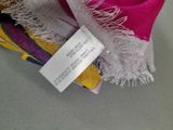 a label on a scarf with a tag attached to it