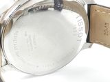 a close up of a watch on a white surface
