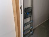 a ladder leaning against the wall next to a door