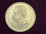 a close up of a gold coin on a black surface