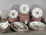 many different types of dishes and cups on the table