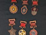 several medals are displayed on a black surface with a black background