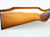 a close up of a rifle on a white surface with a white background