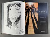 an open book with a drawing of a woman and a man on the cover