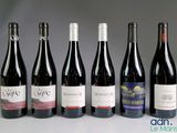 several bottles of wine are lined up on a table