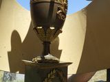 a statue of a vase with a bird on top of it
