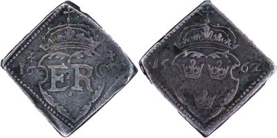 a close up of two silver coins with a crown on them
