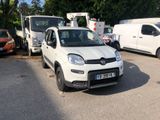 a small white car that is parked in a parking lot