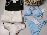 a lot of women ' s underwear and a purse on a table