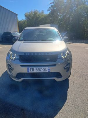 the front of a silver car parked in a parking lot