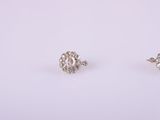 a pair of diamond stud earrings on a white background