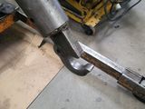 someone is working on a piece of metal with a large hammer