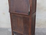 a small wooden cabinet with a door on top of it