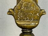 a gold plate with a bird on it on top of a table