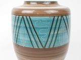 a blue and brown vase sitting on a white surface