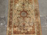 an antique persian rug on the ground with fringes