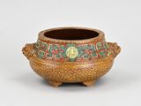 a small pot with a design on the outside of it