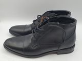 a pair of black leather shoes on a white surface