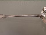 a spoon that is sitting on a glass table
