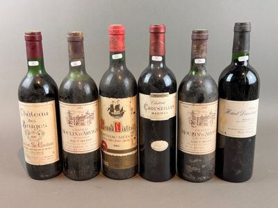 several bottles of wine are lined up on a table