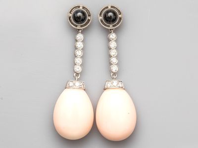 a pair of pearl and diamond earrings