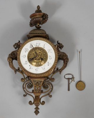 a clock that is hanging on the wall next to a key