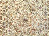 a beige and brown rug with an ornate design on it