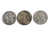 three different types of coins on a white surface