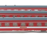 several red and white train cars sitting next to each other on a white surface
