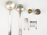 several silver spoons and spoon spoons are arranged on a white surface