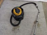 a vacuum that is sitting on the floor next to a hose
