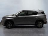 the silver suv is parked on the concrete floor in the room