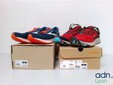 two pairs of running shoes sitting on top of boxes on a table