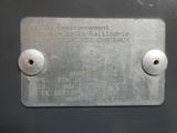 a metal plaque on the side of a metal box