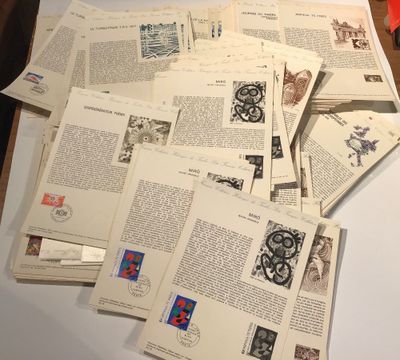 a pile of old books on a table with a pair of scissors