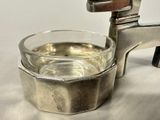 a glass of water in a silver cup on a table