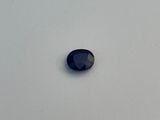 a close up of a blue sapphire stone on a white surface