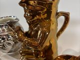 a gold vase sitting on a shelf next to other gold vases