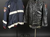 two jackets and a pair of boots on a mannequin stand