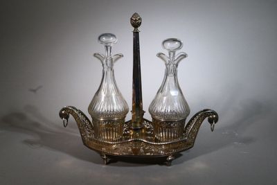 two glass vases sitting on top of a silver tray