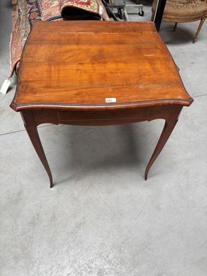 an old wooden table with a small drawer on top of it