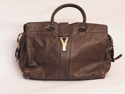 a close up of a brown handbag on a white background