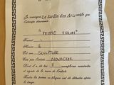 a certificate on a piece of paper on a table