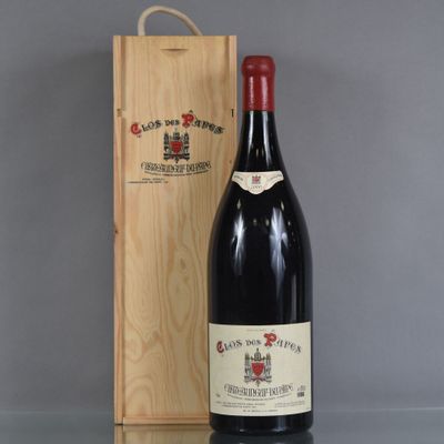 a bottle of wine sitting next to a wooden box