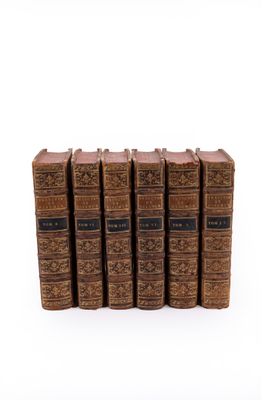 a set of five old books sitting on top of each other