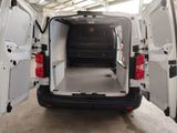 the back of a white van with its doors open in a garage