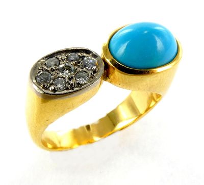 une image représentant une bague en or sertie d'une pierre turquoise et de diamants noirs